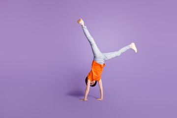 Sticker - Full length body size view of attractive girl standing on hands having fun dancing isolated over violet purple color background