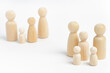 © photo-lime - Family members made from wooden figurines on white background. Family with many children, multi-child or multi-member family. Isolation, social distancing between families