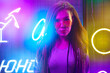 © fotofabrika - Fashion portrait of a young woman in sunglasses posing near neon signs in night club