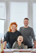 © boytsov - Leisure weekend activity at home - drawing together. Smiling people happy together during coronavirus covid-19 quarantine. Beautiful laughing caucasian family: dad, mom and cute little girl