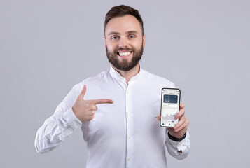 Aufkleber - Happy businessman holding phone with financial app on screen