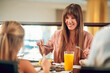 © zinkevych - Happy family sitting at the table in the restaurant