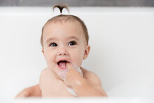 Portrait Of Happy Baby Girl In Bubble Bath