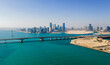 Aerial view of Abu Dhabi skyline rising over the seaside forming modern waterfront of the UAE capital