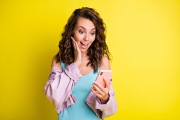 Sticker - Photo of astonished lady arm on cheek open mouth look phone new blog subscribe isolated on yellow color background