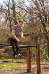 Wall Mural - Man exercising in street workout park