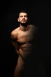 Handsome sport sexy stripped guy portrait on isolated black background
