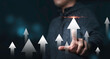 © Dilok - Businessman touching rise up white arrow for business and profit growth concept.