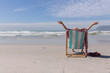 © Wavebreak Media - Caucasian woman wearing bikini sitting on deck chair at the beach