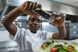 © Wavebreak Media - Happy african american professional chef finishing dish before serving
