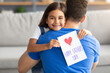 © Prostock-studio - Little daughter greeting young dad with card