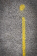 © Ivelin - Yellow line and a dot spray painted on concrete sidewalk making lowercase letter i