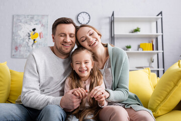 Sticker - Cheerful happy family watching movie on couch,