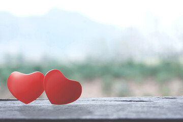 Romantic red two love hearts shape on wooden table. Valentine day greeting card. Hearts on a wooden table. Soulmate concept