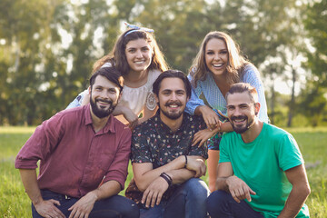 Close-up portrait of a group of friends in a summer park.