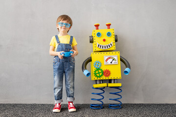 Canvas Print - Happy child with toy robot