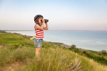 Wall Mural - Happy child against blue sea and sky background