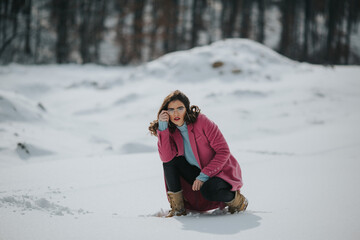 Poster - Bosnian woman sitting on snow and posing