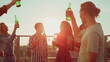 © stockbusters - Smiling friends toasting with beer on terrace. Multiethnic people dancing party