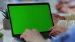 © stockbusters - Man hands typing green screen laptop office. Unknown male person using computer