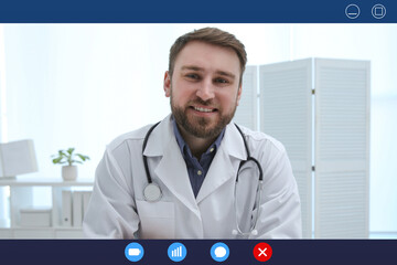 Canvas Print - Pediatrician consulting patient online using video chat in clinic, view from webcam