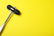 © New Africa - Reflex hammer on yellow background, top view with space for text. Nervous system diagnostic
