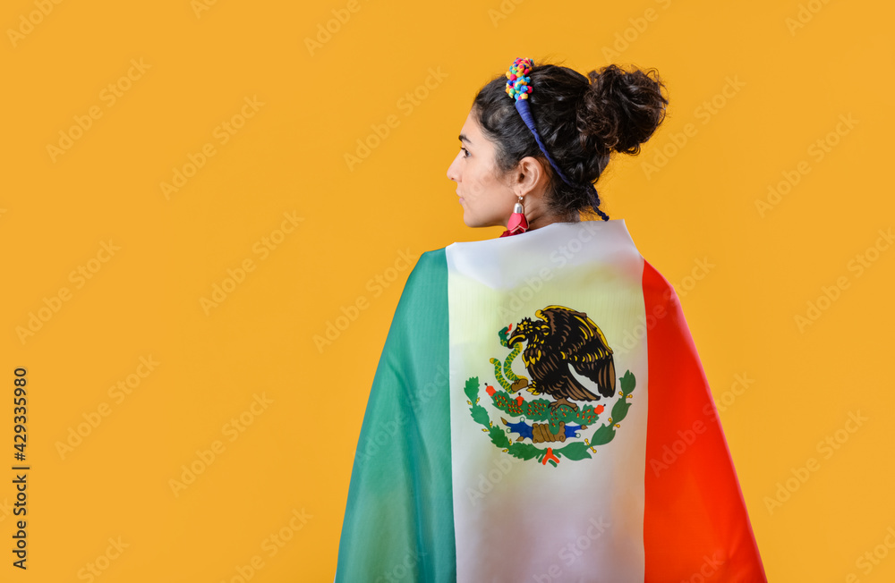 Young beautiful woman with Mexican flag on color background