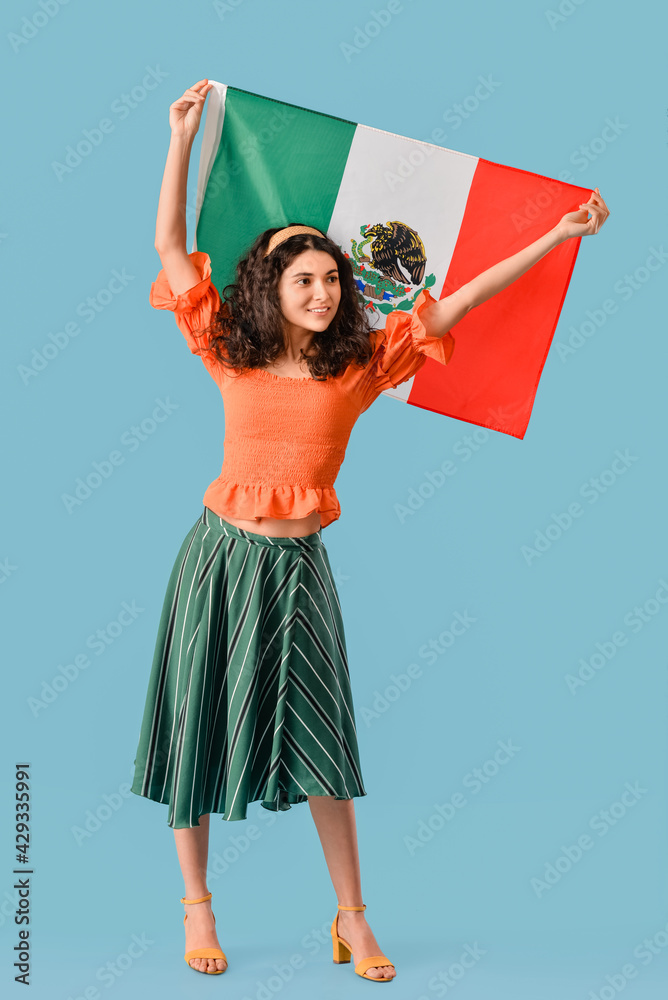Young beautiful woman with Mexican flag on color background