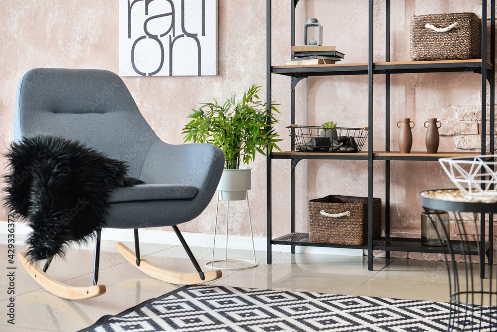 Interior of modern room with armchair and shelf unit