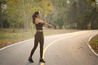 © Prathankarnpap - Young woman runner warming up before outdoor workout in the evening.