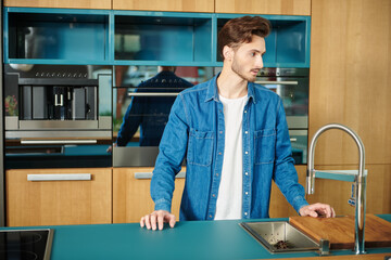 Wall Mural - man stands at kitchen