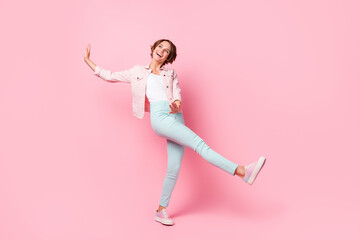 Wall Mural - Full body photo of positive charming young woman dreamy look empty space dance isolated on pink color background