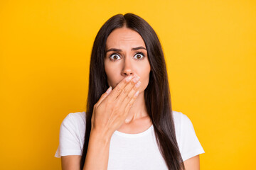 Wall Mural - Photo of upset guilty young lady wear white t-shirt big eyes arm cover lips isolated yellow color background