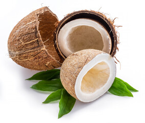 Wall Mural - Split coconut fruit over green leaves isolated on white background.