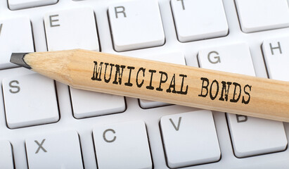Poster - Text MUNICIPAL BONDS on wooden pencil on white keyboard. Business concept