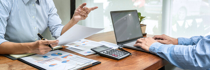 Aufkleber - Close up of two business colleagues holding data document and typing business data on laptop
