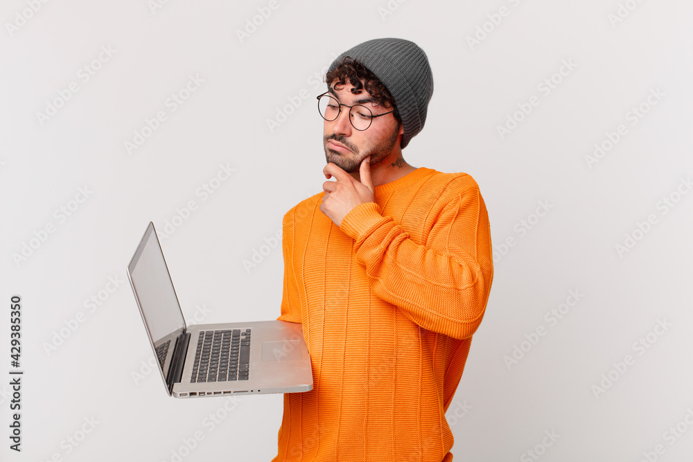 nerd man with computer thinking, feeling doubtful and confused, with ...