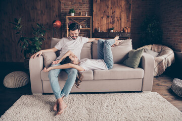 Poster - Portrait of attractive cheerful careful couple soulmates sitting on divan enjoying relaxing at loft style interior home house indoor