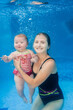 © Serhii - Mom holds daughter are immersed in water, swimming under water in paddling pool. Diving baby. Learning infant child to swim. Young mother or swimming instructor and happy little girl.