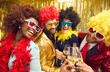 © Studio Romantic - Corporate costumed party celebration. Happy overjoyed friends or colleague in funny colorful wigs and eyeglasses clinking wineglass with champagne. People cheers on bright glittering headshot portrait