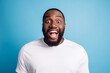 © Tetiana - Photo of positive astonished young man open mouth have fun wear white t-shirt over blue background