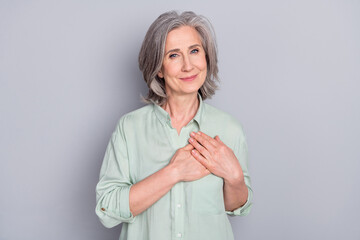 Sticker - Photo of happy smiling dreamy lovely granny hold hands chest thankful grateful isolated on grey color background