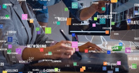 Poster - Composition of digital icons and business text over woman using computer and graphic tablet
