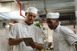 © Wavebreak Media - Portrait of diverse race male professional chefs discussig over tablet