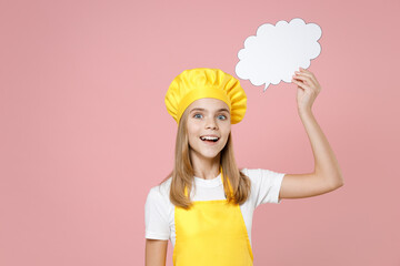 Teen girl chef cook confectioner housewife baker in yellow apron white tshirt cap hold empty blank Say cloud speech bubble for promotional content isolated on pink background studio Food cake concept