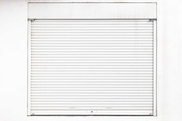 The white roller shutter door of the store is closed