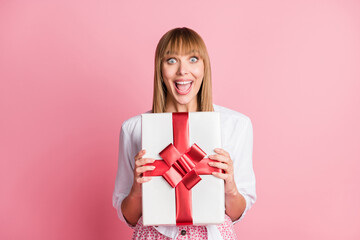 Sticker - Photo of young excited woman happy positive smile get gift present box holiday isolated over pastel color background