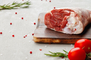 Raw lamb shanks on wooden board close up