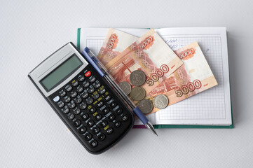 calculator, money notepad and pen on white background. Rubles. Accounting for finances. Savings