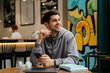 © Drobot Dean - Happy young brunette man holding mobile phone